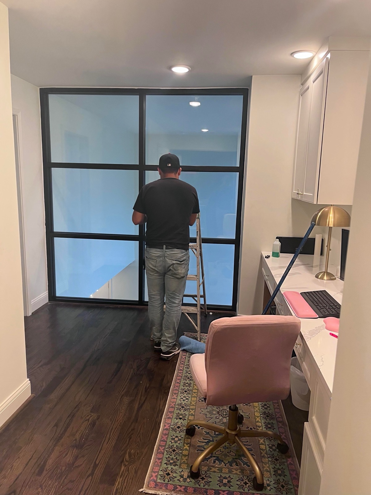 Glass partition wall in home office — black frame with frosted panels