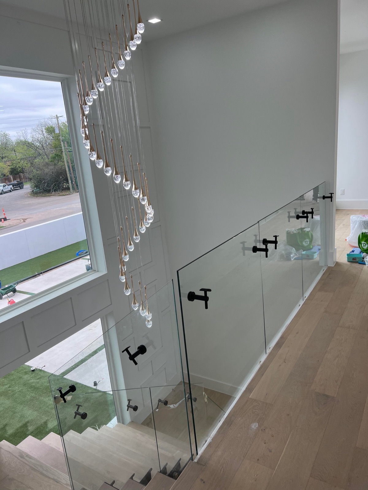 Frameless glass stair railing with crystal chandelier