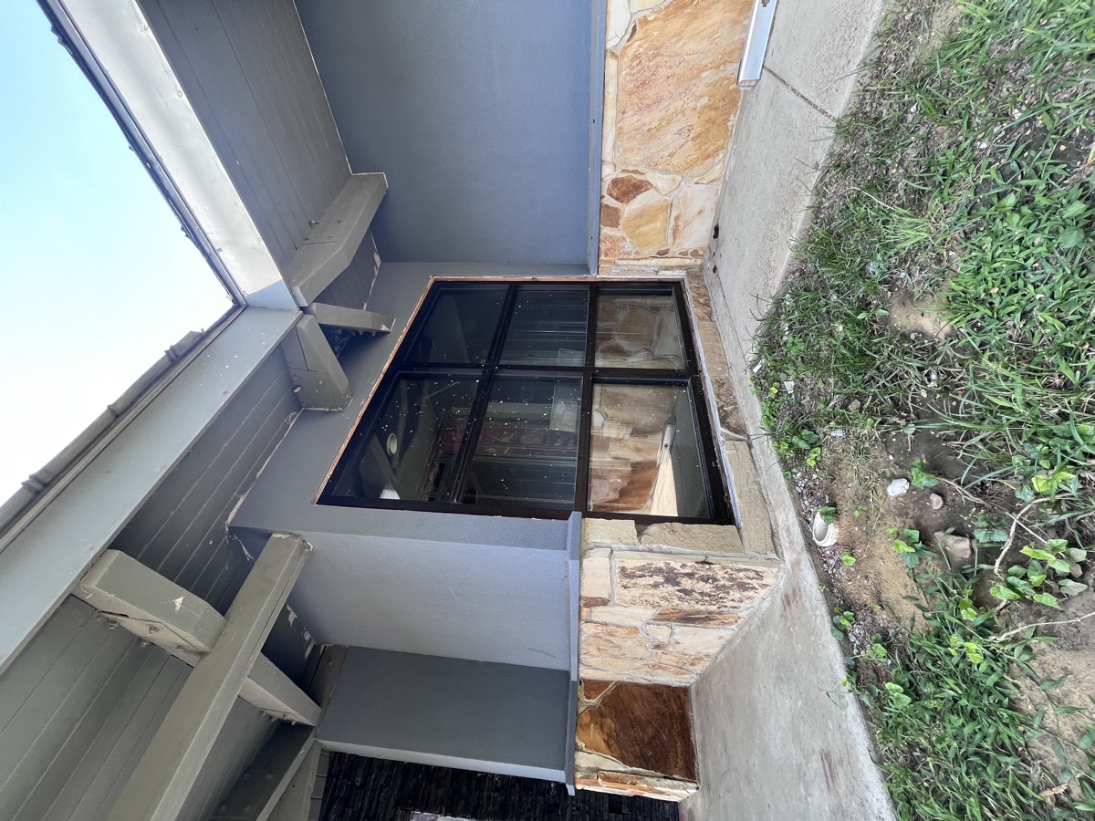 Window installation on stone and brick exterior