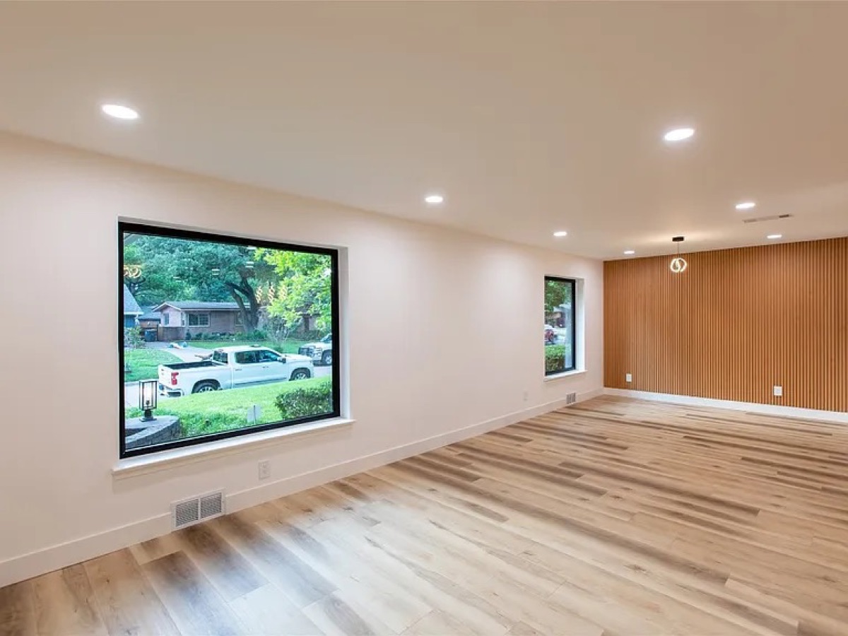 Large picture window in modern new construction — hardwood floors