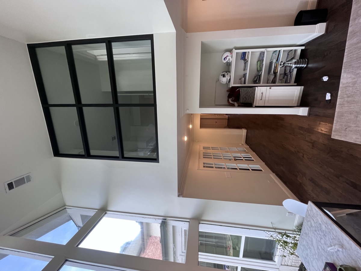 Black-framed glass partition separating living spaces
