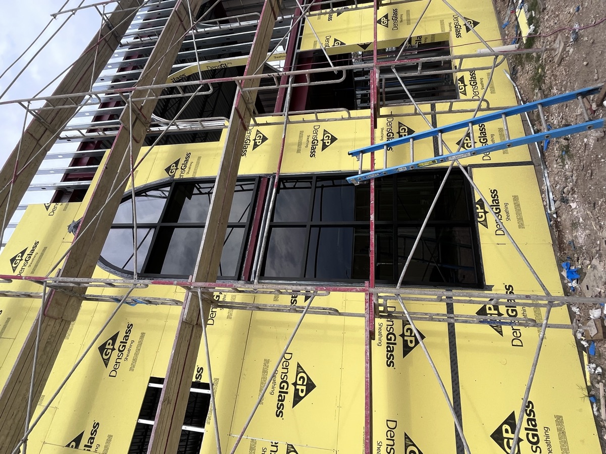 New construction curtain wall and window installation with scaffolding
