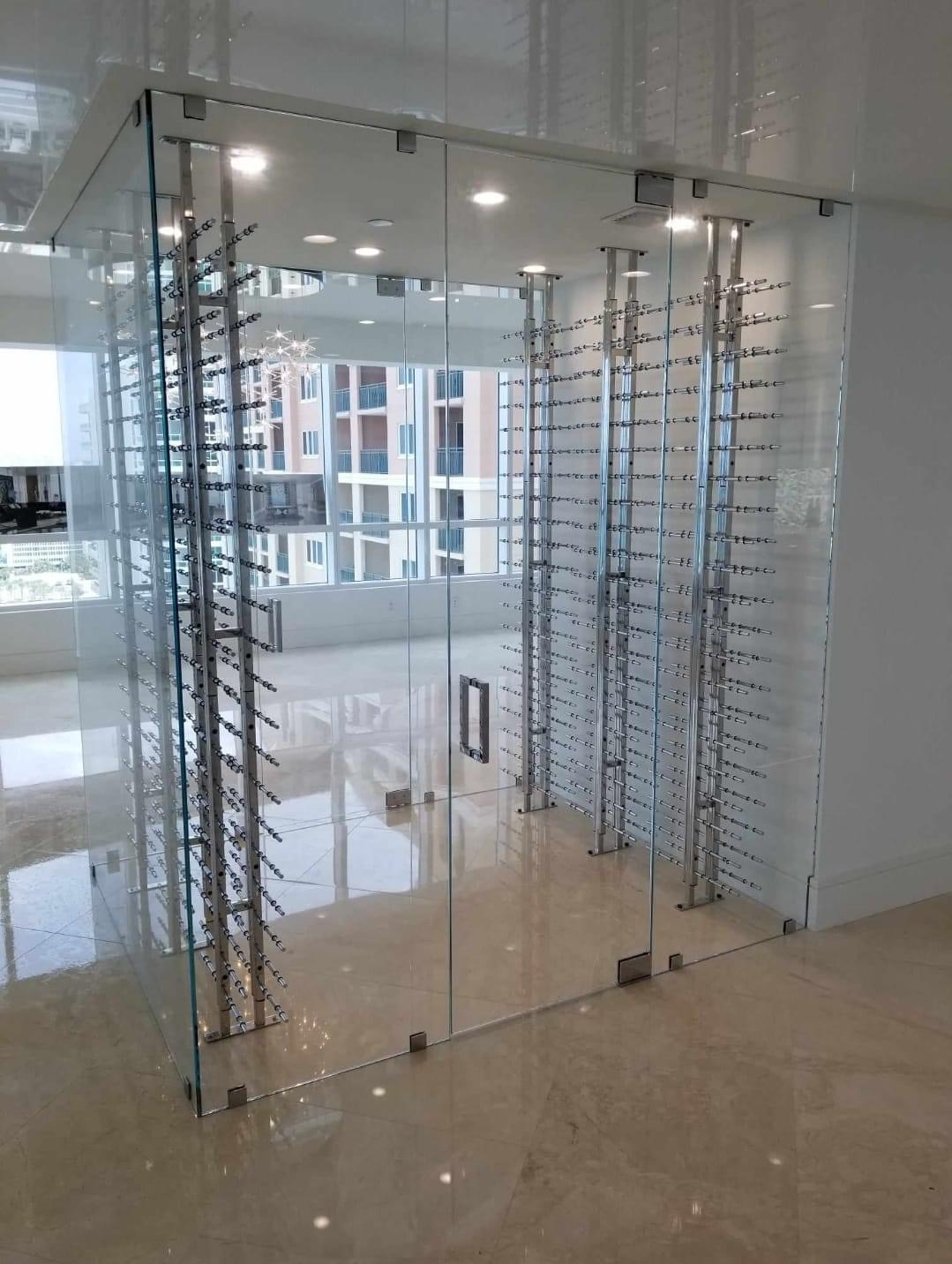 Frameless glass wine room enclosure with chrome wine peg racks
